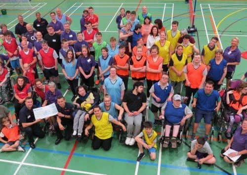 Sleaford firefighters present their donation to the Laffletics Club at their 15th anniversdary sports festival. EMN-190718-170438001