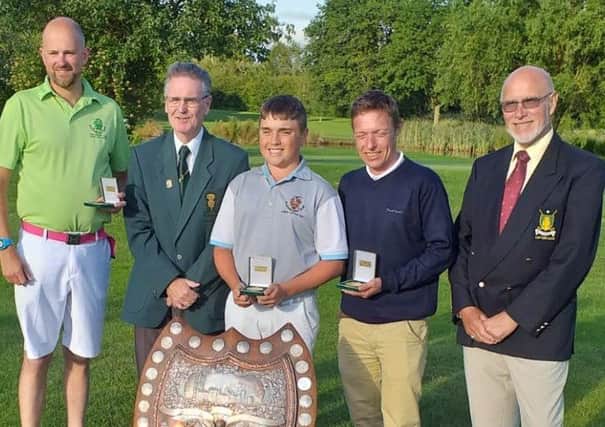 The winning Sleaford team, Dan Withers (left), Michael Baines (centre), and Dillon Ormesher (second right) with the sizeable Lunn Shield EMN-190718-124405002