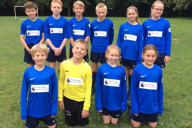 Osbournby Primary School pupils show off their new kit.