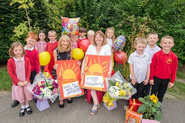 Mrs Akhurst and Miss Knowles surrounded by children on their last day.
