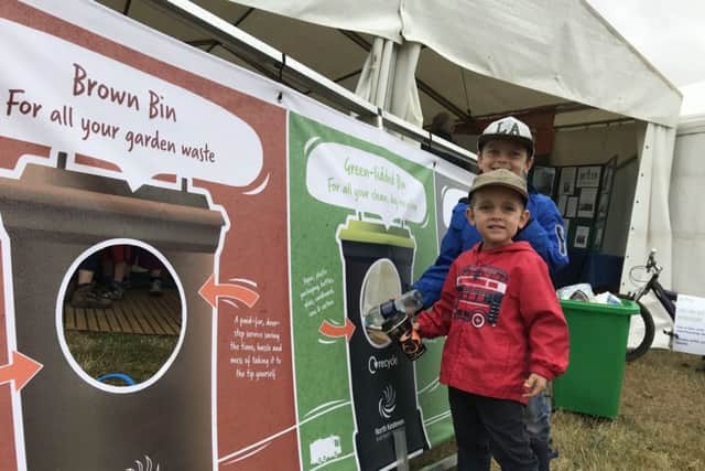 Learning to recycle right on the NKDC stand. EMN-190723-170306001