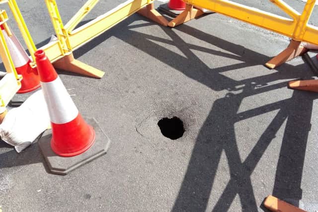 Behind the barriers.