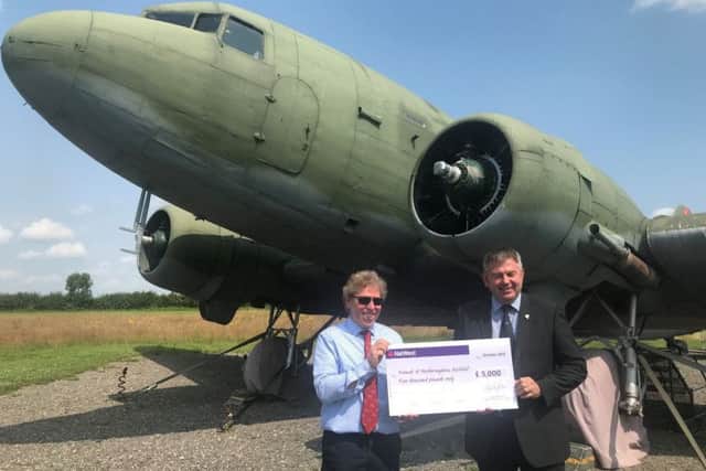 Coun Richard Wright (right) presents a cheque for £5,000 to Andrew Scoley, chairman of the Friends of Metheringham Airfield, for the new hangar for the Dakota. EMN-190724-115537001