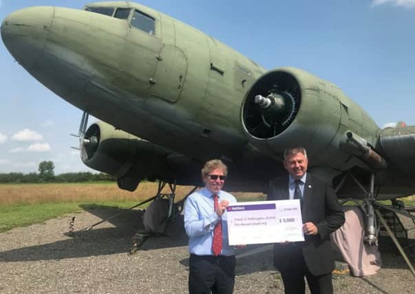 Coun Richard Wright (right) presents a cheque for £5,000 to Andrew Scoley, chairman of the Friends of Metheringham Airfield, for the new hangar for the Dakota. EMN-190724-115537001