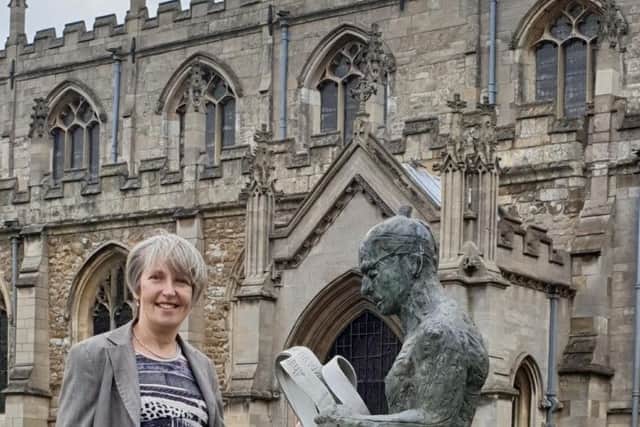 Wilkin Chapman Partner Flora Bennett outside the beautiful St James
Church, Louth with the towns Meridian Line Man a popular draw for visitors.