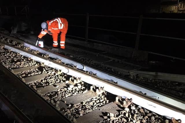 Netwpork Rail engineers have been painting part of the steel rails white to reflect the sun's heat. EMN-190724-163156001