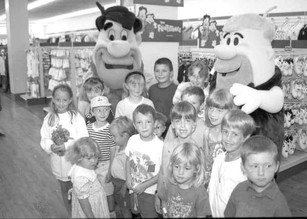 A page right out of history ... Youngsters at Woolworths, in Strait Bargate, Boston, 20 years ago this week, with Fred Flintstone and best friend and next-door neighbour Barney Rubble.