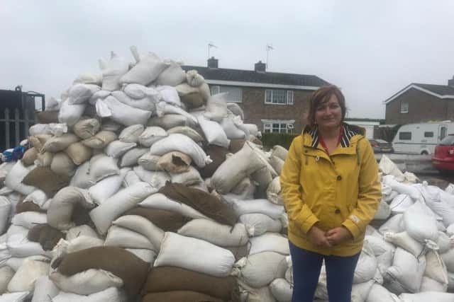 Michelle Howard, ELDC assistant director, people, by the pile of contaminated sandbags which need to be tested before disposal.