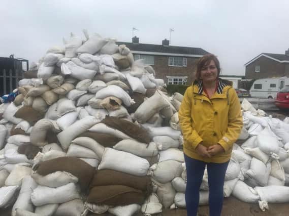 Michelle Howard, ELDC assistant director, people, by the pile of contaminated sandbags which need to be tested before disposal.