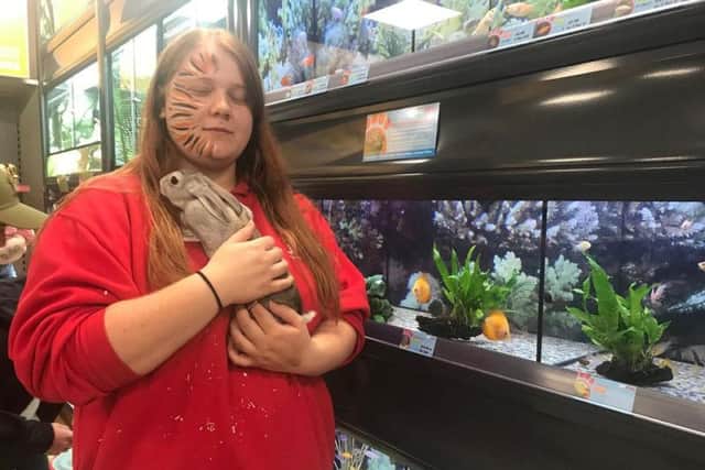 Sales assistant Kiera Carrington-Hunt with one of the store's Rex rabbits.