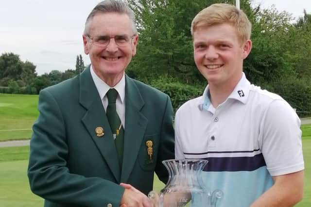 Sam with the Lincolnshire Poacher trophy and county president Harvey Harrison EMN-190729-134204002