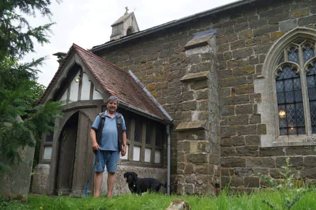 Churchwarden David Ashton-Hill with his faithful dog Bruno outside Greetham Church
