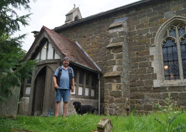 Churchwarden David Ashton-Hill with his faithful dog Bruno outside Greetham Church