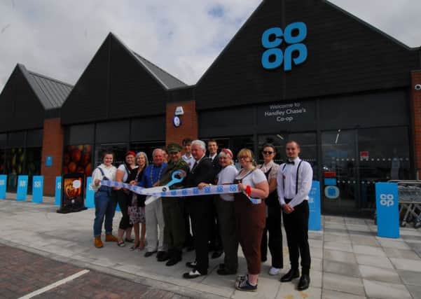 Mayor Adrian Snookes and Deputy Mayor Anthony Brand join manager Rob Taylor and staff at the opening of the new Co-op store in Handley Chase, Sleaford. EMN-190208-155659001