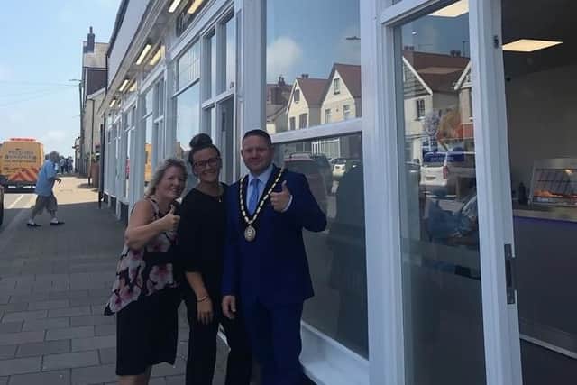 Mayor of Skegness Coun Mark Dannatt joins Seaview Fisheries owner Marie Ramsay and her daughter, Lindsay for the re-opening of the chippy.
