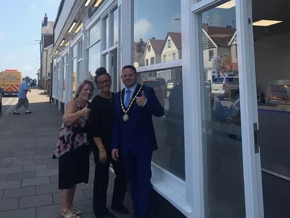 Mayor of Skegness Coun Mark Dannatt joins Seaview Fisheries owner Marie Ramsay and her daughter, Lindsay for the re-opening of the chippy.