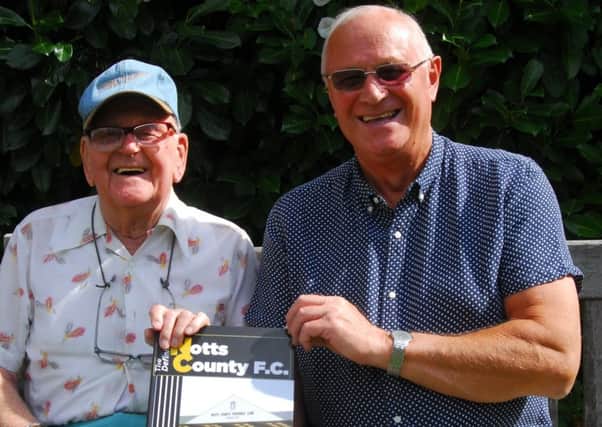 Les Stancer and Les Gadd with the history book on Notts County FC. EMN-190209-161637001