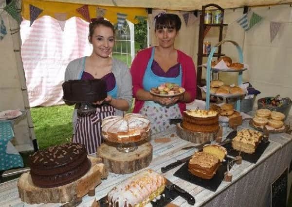 Eleanor Hurrell and Charlotte Hurrell serving tea and cakes at last years festival