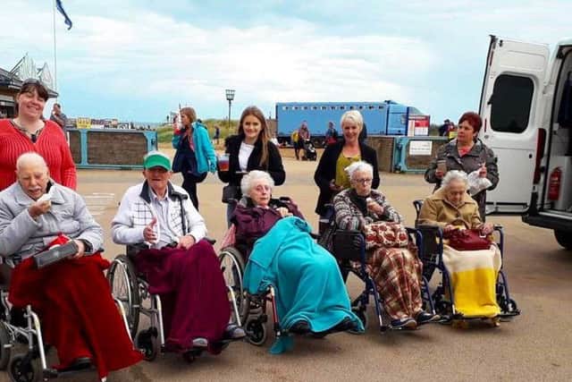 Greenacres residents and staff at the seaside thanks to help from TASL's ambulance crews. EMN-190909-133854001