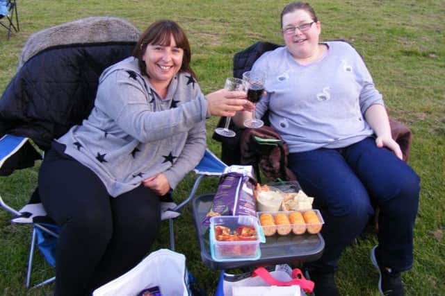 Victoria Backhouse and Linda Bailey raise a toast to their picnic in front of the movies. EMN-190909-194237001