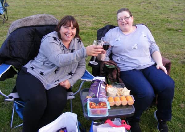 Victoria Backhouse and Linda Bailey raise a toast to their picnic in front of the movies. EMN-190909-194237001