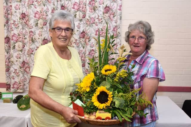 Lyn Small, right, was Best in show and 1st prize with Floral Art, pictured with judge May Bennett.
Photo by John Edwards EMN-190409-133845001