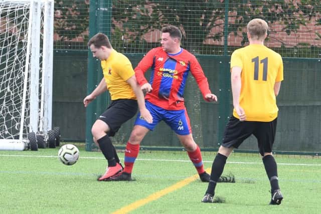 Northgate Olympic (red) v Kirton Reserves (yellow). Liam Kishere (red), Jack Reeson (yellow)