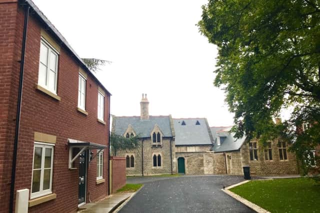 Schools out but new homes are in at Quarrington's old school on Grantham Road thanks to an NKDC project to save the building and create nine new rental homes. EMN-191009-131649001