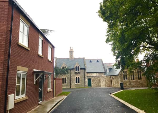 Schools out but new homes are in at Quarrington's old school on Grantham Road thanks to an NKDC project to save the building and create nine new rental homes. EMN-191009-131649001