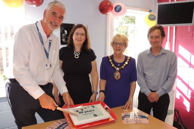 Cutting the 80th anniversary cake for Citizen's Advice. From left - CEO for Citizens Advice Mid Lincs Kingsley Taylor, MP Dr Caroline Johnson, NKDC chairman Coun Susan Waring and Citizens Advice Mid Lincs chairman Ben Ellis. EMN-190917-122909001