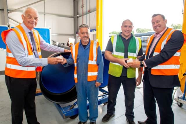 Operations Director John Bush presents a 40th anniversary cupcake to a member of staff.