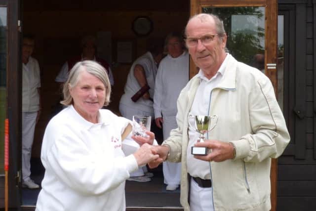 Pauline Donner, Chair of Woodhall Spa Croquet Club, presents Barrie Darling with the winners cup and an engraved glass.