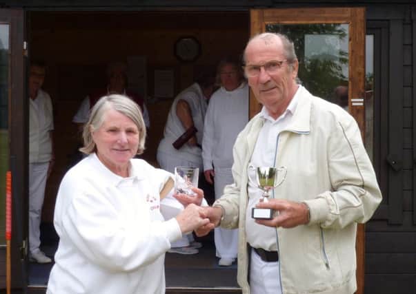Pauline Donner, Chair of Woodhall Spa Croquet Club, presents Barrie Darling with the winners cup and an engraved glass.