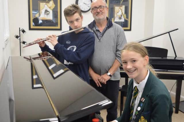 Kai and Rhianna with Grahame, their GCSE music tutor.
