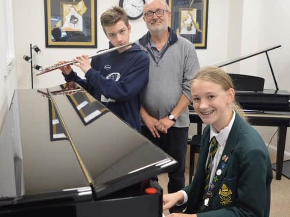 Kai and  Rhianna with  Grahame, their GCSE music tutor.