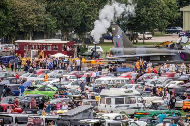 Crowds at Skegness Water Leisure Park around some of the 500 vehicles at the Classic Wheels event, as the Lincolnshire Coast Light Railway's 1903-vintage steam locomotive Jurassic steams towards the XS456, an English Electric Lightning T5. Photo: Dave Enefer/LCLR