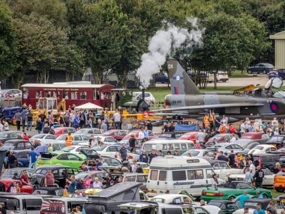 Crowds at Skegness Water Leisure Park around some of the 500 vehicles at the Classic Wheels event, as the Lincolnshire Coast Light Railway's 1903-vintage steam locomotive Jurassic steams towards the XS456, an English Electric Lightning T5.  Photo: Dave Enefer/LCLR