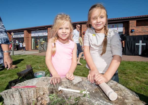 Pippa Webb age 5 and Millie Webb age 7 making clay art at the Touchwood Forest School stand EMN-190923-142105001