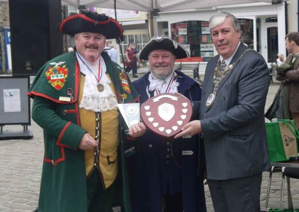 Sleaford Town Crier John Griffiths (left) receives his winner's trophy at the Otley Town Crier Competition. EMN-190924-151647001