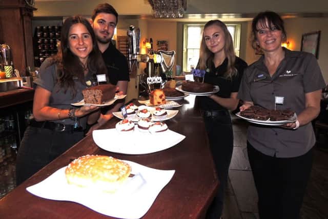Serving up cakes for Macmillan's coffee morning at The Bustard Inn, Rauceby, from left - Robyn Clermont, Matt Grinney, Olivia Balchin and landlady Lesley Lonsdale. EMN-190930-144853001