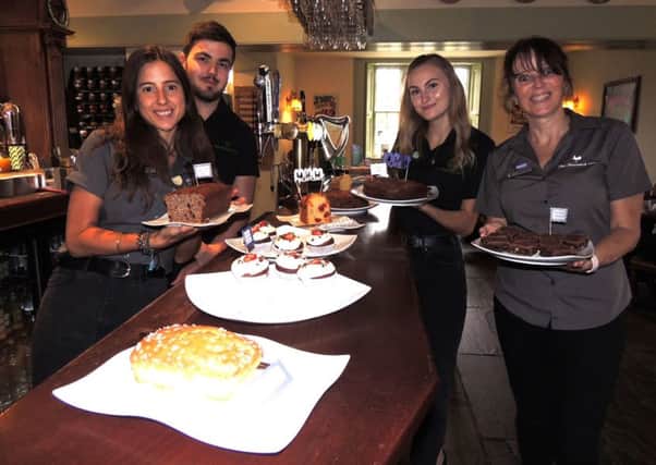 Serving up cakes for Macmillan's coffee morning at The Bustard Inn, Rauceby, from left - Robyn Clermont, Matt Grinney, Olivia Balchin and landlady Lesley Lonsdale. EMN-190930-144853001