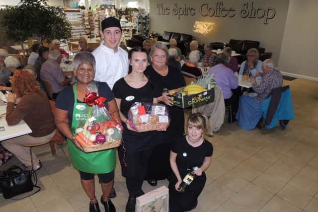 With some of the raffle prizes, staff at The Spire Coffee Shop in Anwick Garden Centre histed an afternoon tea for Macmillan. From left - Raj Maidment, chef Lewis Smith, Lauren Bradford, Tina Clewlow and Jess Cook. EMN-190930-144842001