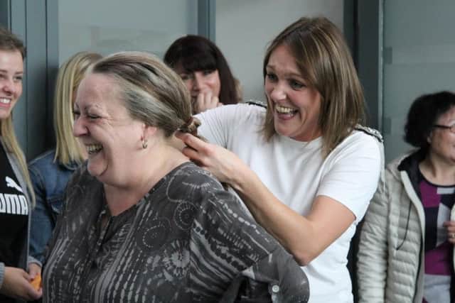 Lisa Willard, a Legal Secretary at Hodgkinsons Solicitors, won the chance to cut the hair of her colleague Amanda Smith for charity.