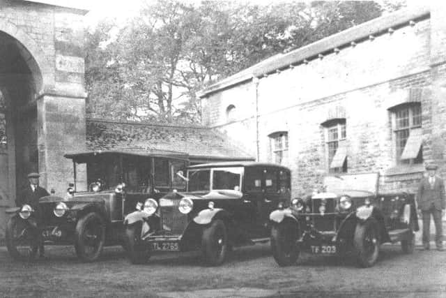 A bygone view of Leadenham House estate's drivers and their cars outside the stables. EMN-190930-164739001