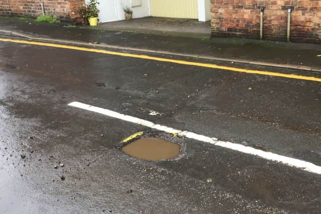 Pot holes in Market Rasen's Church Street EMN-190110-062233001