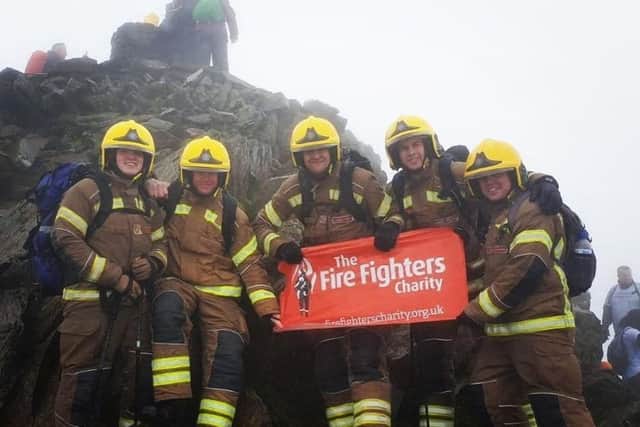 The firefighters reach the summit of Mount Snowdon in their full kit. Pictured, from left, is Ollie Baldham, Ben Gleadhill, Daniel Cheetham, Charlie O'Neil and Sam Newlyn.