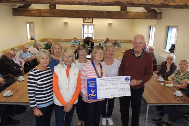 Sleaford Lionesses president Pam Kyte presents the donation of ?500 to Derek Arnold, chairman of Sleaford Parkinsons Support Group. EMN-190710-190108001