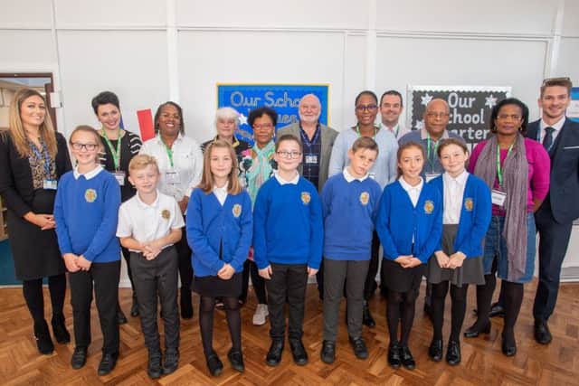The visitors from Guadeloupe, pictured alongside staff and pupils at Grimoldby Primary School last week.