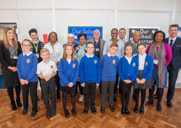 The visitors from Guadeloupe, pictured alongside staff and pupils at Grimoldby Primary School last week.