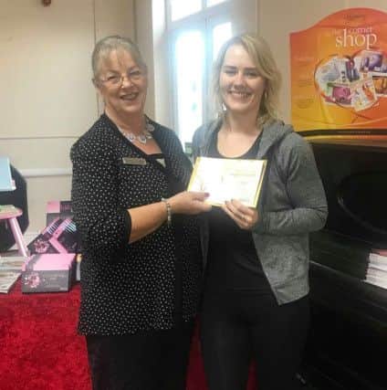 Emily Dawson, right, pictured receiving her Club 50 award from Slimming World consultant Chris Brankin.